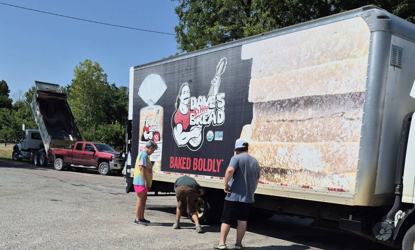 A delivery box truck getting roadside tire help from the BJ's crew